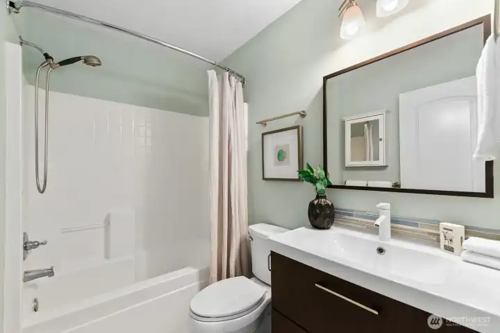 Full hall bath with tub/shower combo & updated floating vanity, mirroring half bath downstairs. Full hall bath with tub/shower combo & updated floating vanity, mirroring half bath downstairs.