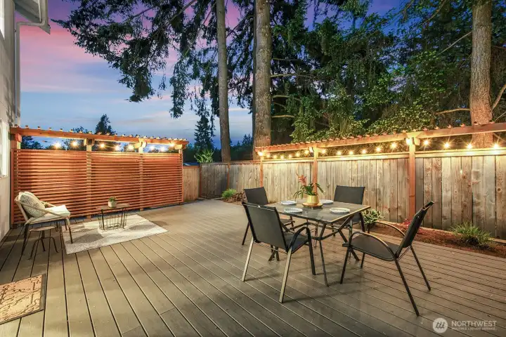 Expansive Trex deck at dusk with integrated lighting & a glowing western sunset sky. Expansive Trex deck at dusk with integrated lighting & a glowing western sunset sky.