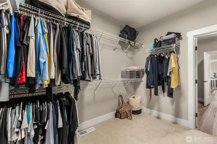 Primary bedroom walk in closet. Primary bedroom walk in closet.