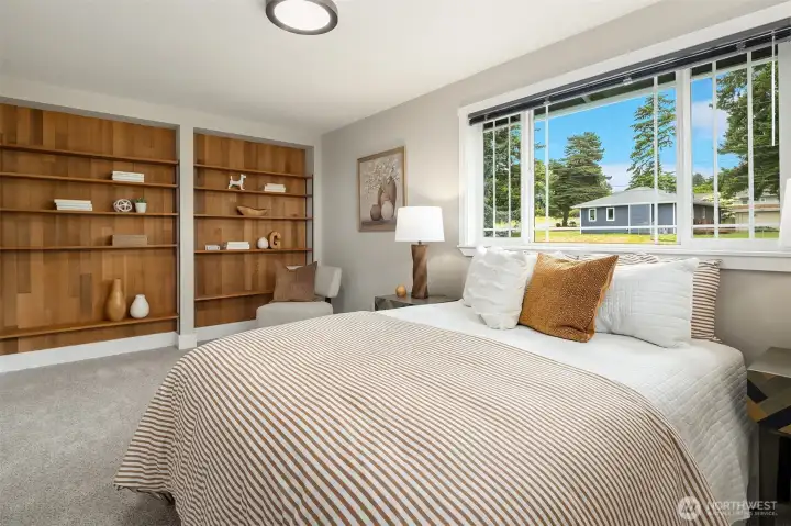 2 of 3 bedroom showing wood shelves.
