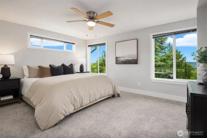 Primary bedroom with views and attached 3/4 bathroom.