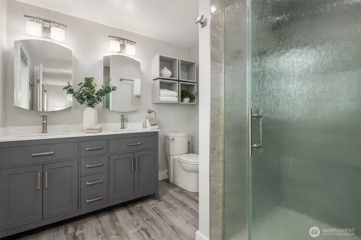 3/4 primary bathroom with double sinks and large walk-in shower.