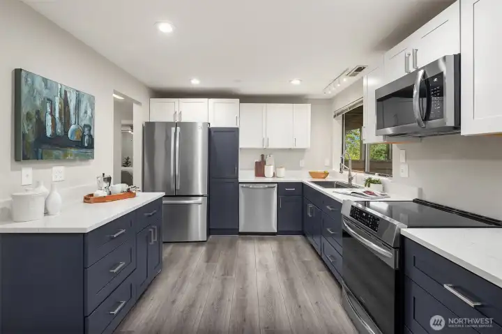 Lower level kitchen features quartz counters and stainless appliances.