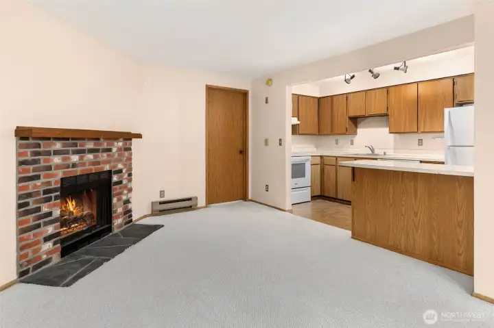 The wood burning fireplace can be enjoyed from the cozy living room or while preparing or enjoying a meal.