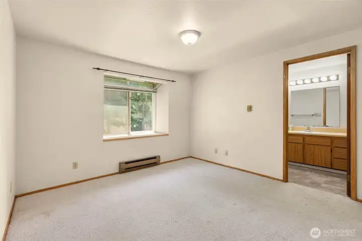 Another angle of the large bedroom, with its en suite full bathroom, where you'll find the in unit washer/dryer.