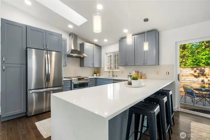 Quartz counters and peninsula offers a great gathering spot.