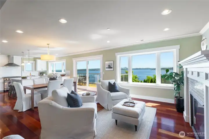 The open concept design flows from the main level living space with custom tiled gas fireplace, into the dining area and tastefully appointed kitchen, all flooded with natural light and panoramic views.