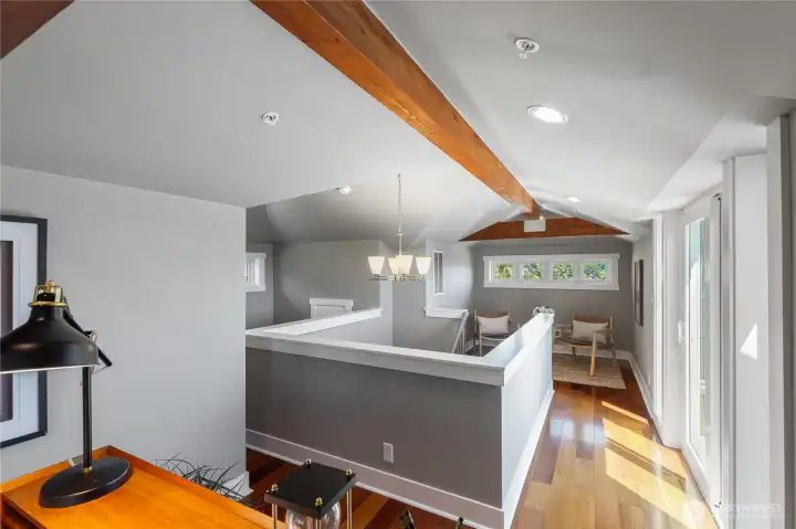 The upper level offers a private office, writers loft or artists studio space with vaulted ceilings, dual works areas and a walk out, lake view deck.