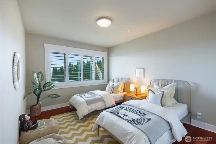 One of two bright and generously sized additional bedrooms. Custom wood plantation shutters offer privacy to the bedrooms.