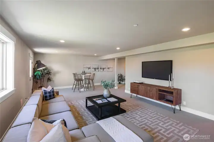 The bright and sunny lower level offers high ceilings and endless flexibility as a family, media and recreation room or to host guests as well as create a fitness space or additional work studio.