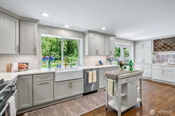 Kitchen has quartz counter tops and under cabinet lighting