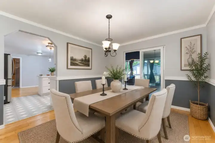 Dining Area with Access to Living, Kitchen and Covered Deck - Virtually Staged