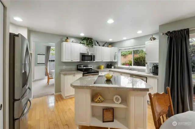 Main island in the kitchen serves as a gathering place for entertaining.