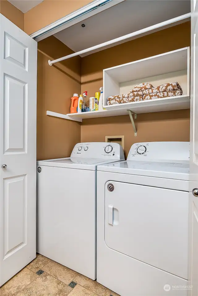 Full size laundry IN the condo, complete with storage shelves and a drying bar