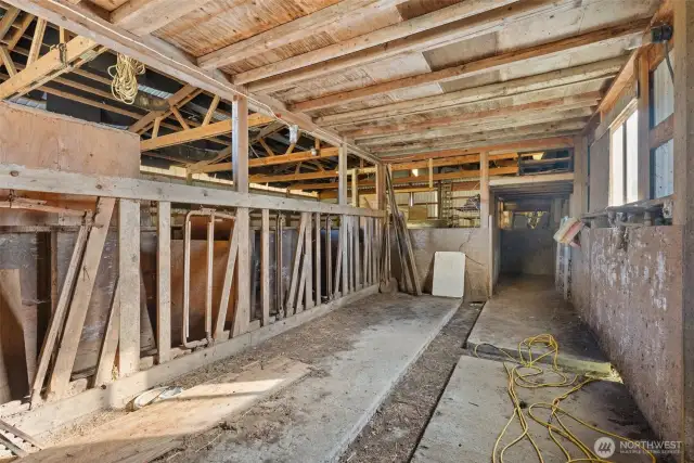Barn interior with livestock area and head gates.