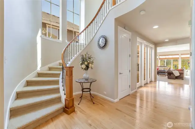 Dramatic entryway with circular stairway