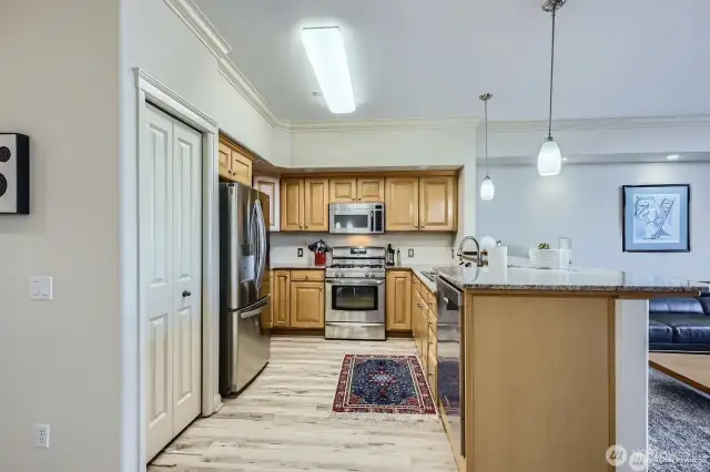 Modern kitchen with granite counters, easy-care floors, lots of storage space - including a pantry.