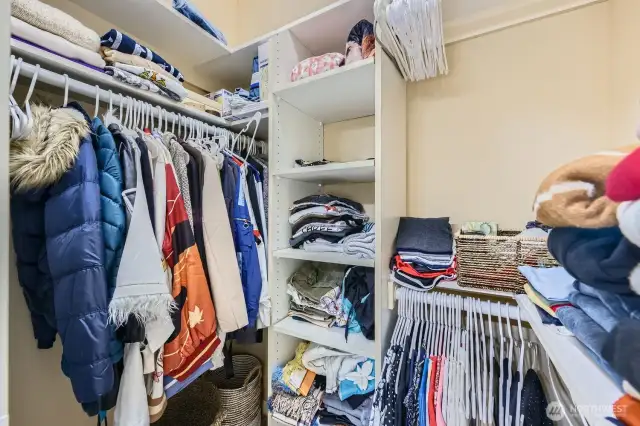 Primary walk-in closet with organizers.
