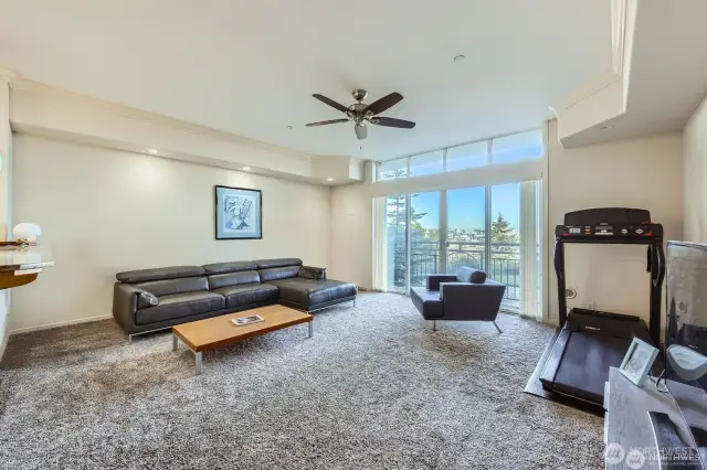 Bright and spacious living room with crown moulding detail and transom windows.