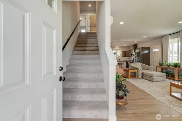 Entryway takes you up the wide staircase or into the main living area