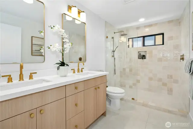 A very sumptuous bath with gold elements that carry through this beautiful home.