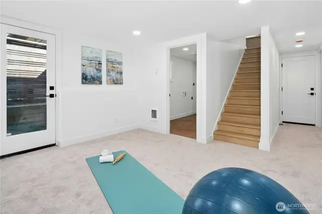 We're calling this the recreation/flex space since there's so many options. It also has outdoor access to the backyard! The room to the left of the stairs is a very generous laundry room.