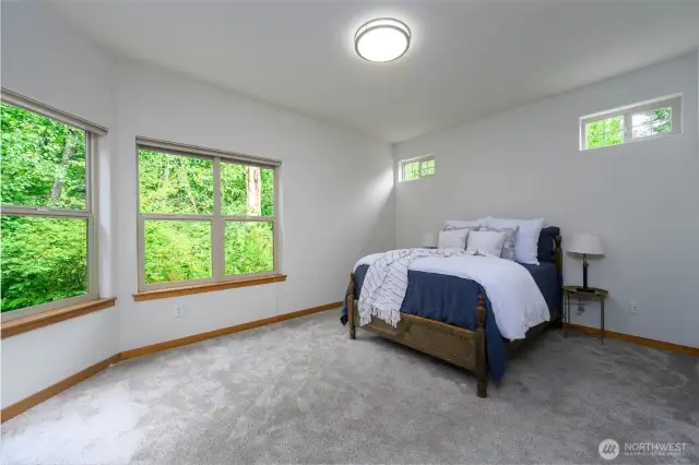 Primary bedroom that also has a private deck overlooking the creek.