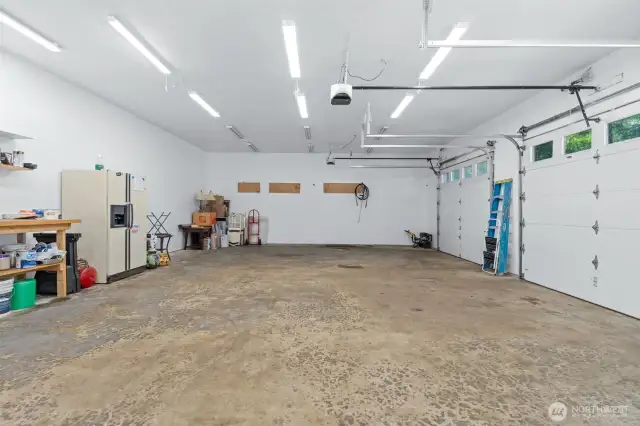 Large, oversized garage has bolts already drilled for a car lift.