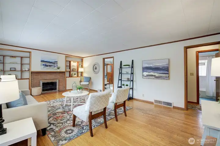 Cozy fireplace is flanked by built-in bookcases