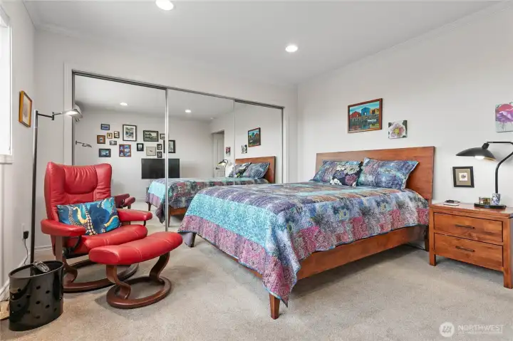 Main bedroom with lots of closet space behind the mirror