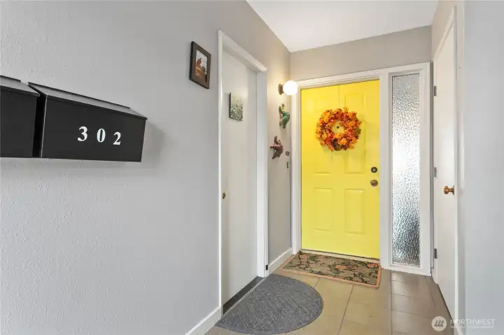 Access to the unit from both alley parking and the garage. The door to the left leads to the easterly facing deck, the door to the right is for the private storage.