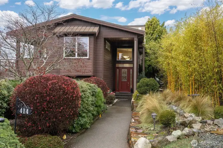 There is a welcoming and defined entry from the street, surrounded by incredible landscape.