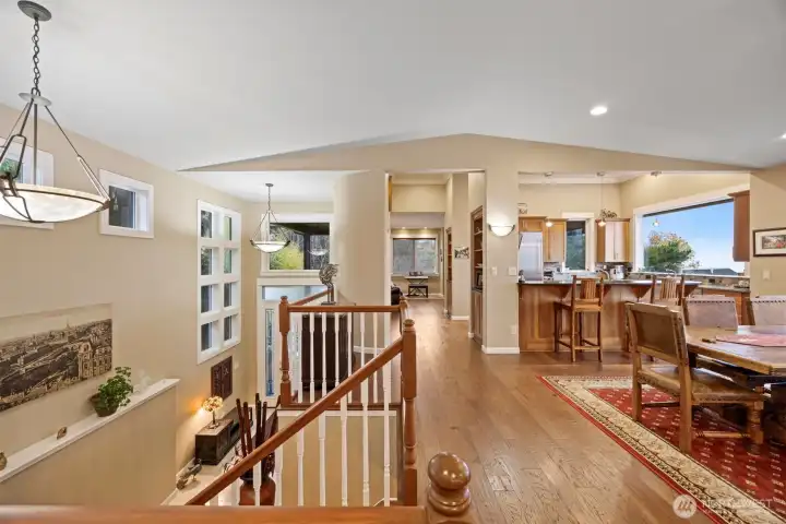 THe main floor is very open and has the kitchen and library at one end with the dining in the middle and the living room, den, nd primary suite at the other end.