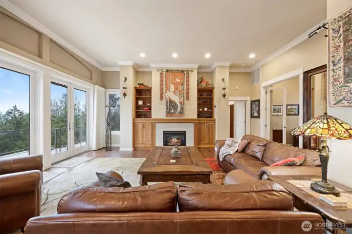 Looking across the living room with the primary bedroom beyond and the office behind the French doors to the right.