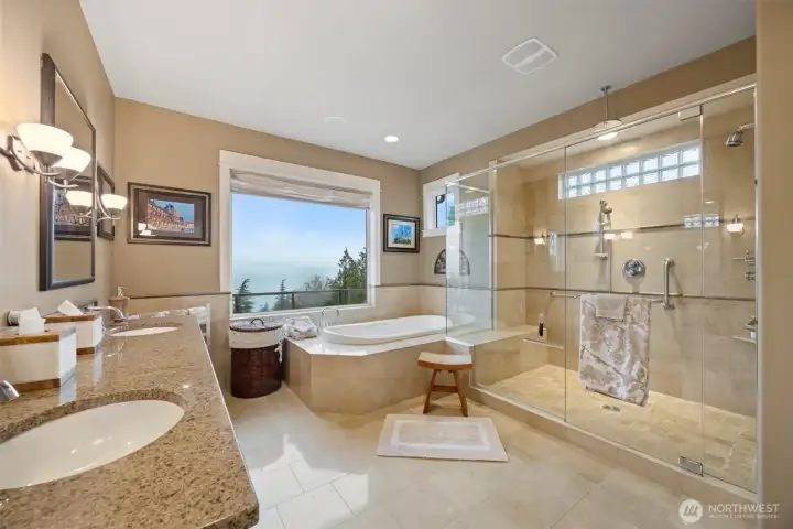 The primary bathroom is also very spacious with a deep soaking tub and oversized 3-head shower that take in the stunning views, and a separate toilet room.