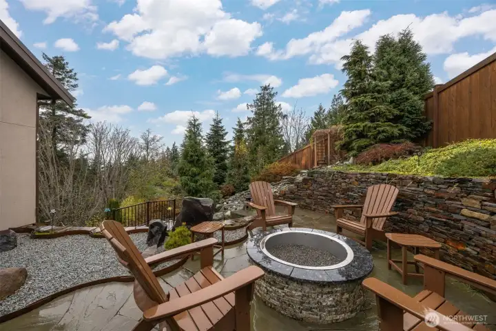 The firepit is just off the office on the rear side of the home and adjacent to the waterfall in the extremely private rear yard.