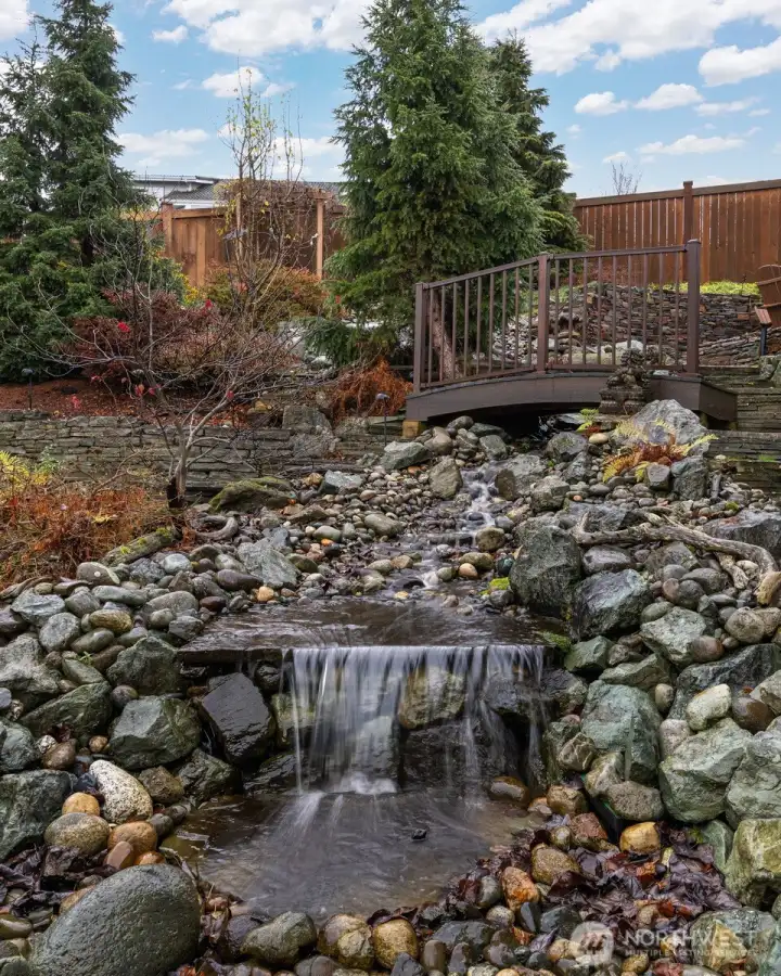 The water fall with the bridge are part of the "oasis" in the private back yard.