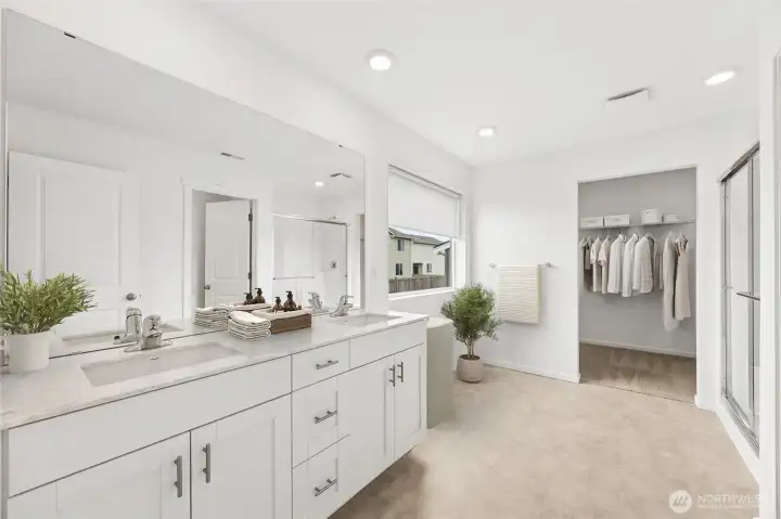 Beautiful primary spa-like bathroom with separate water closet.  Virtually staged.