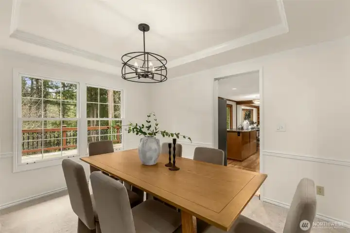 Dining room with updated light fixture overlooks the peaceful outdoors