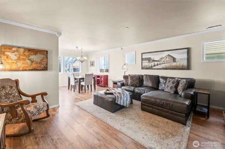 Beyond the office, the home opens to a living room that seamlessly connects to the dining room and kitchen.