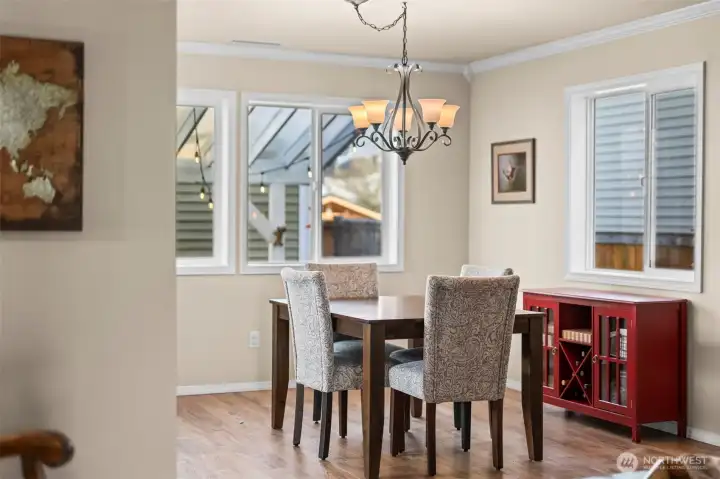 Windows on three walls make the living, dining, and kitchen bright.