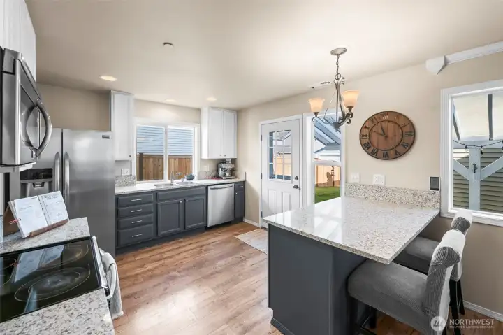Two tone cabinets, quartz counters, and stainless appliances make this space as beautiful as it is functional.