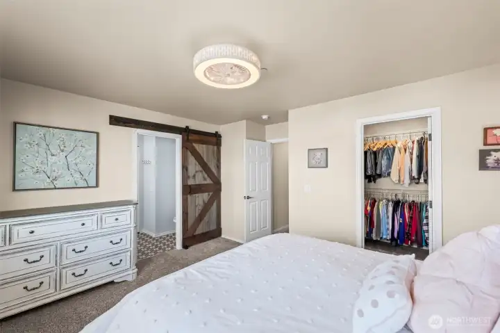 A generous primary suite with a walk-in closet and remodeled bathroom awaits.