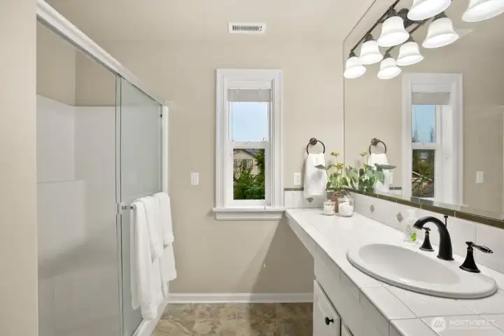 Primary bathroom with walk-in shower plus linen closet-this home has it all!