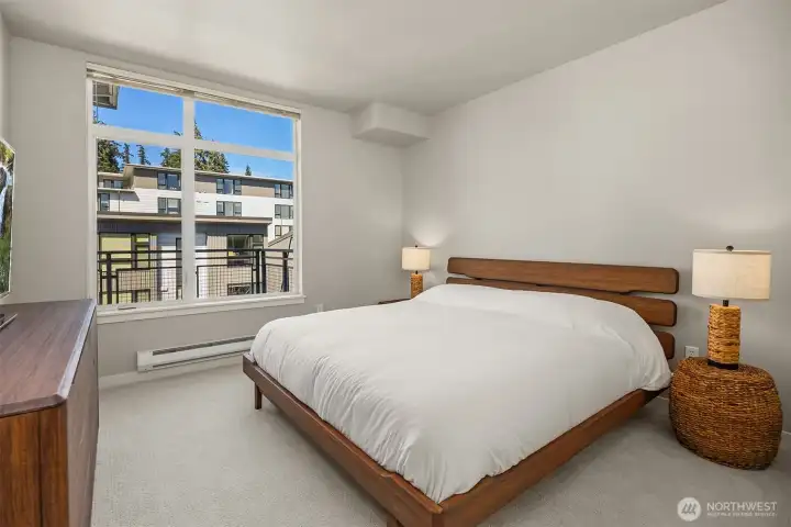 The spacious bedroom offers a calm retreat with room to unwind at the end of the day.