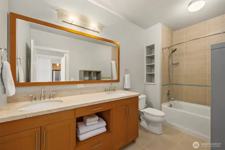 The full en-suite bath features generous counter space and classic finishes.