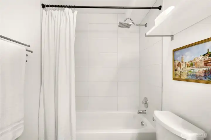 White ceramic tile shower surround.