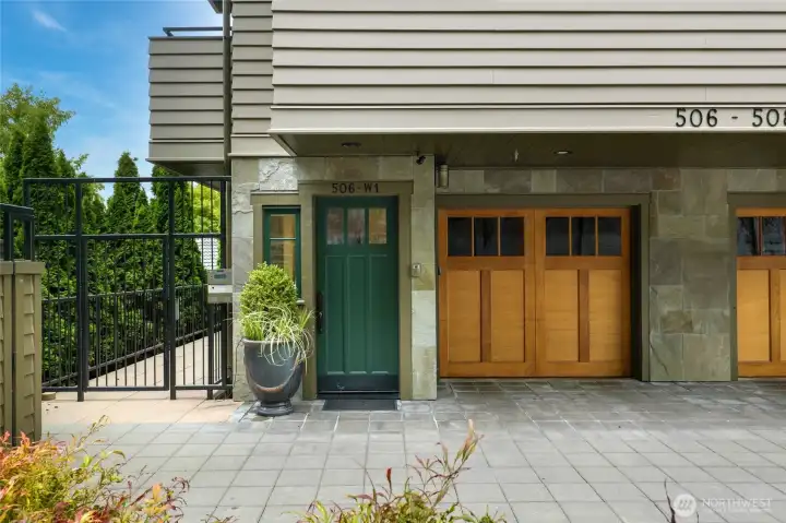 Entry with attached garage and off-street parking for 2 cars. A modest entry belies the unique interior!