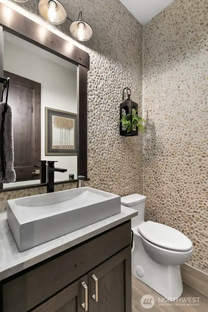 Hall guest bath with custom pebble walls