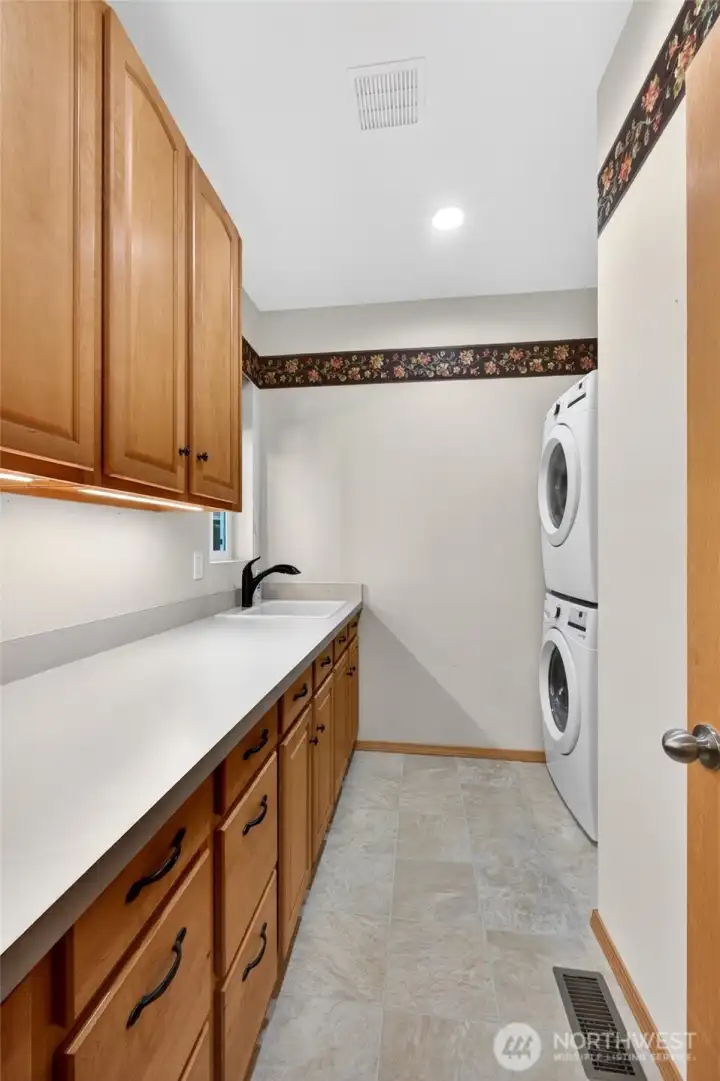 Laundry space could potentially be converted to another bathroom, it was originally designed that way. Plumbing for the toilet is under the sink area. The laundry was moved from the kitchen pantry.